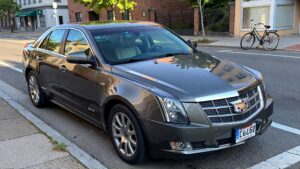 Gray Cadillac parked on street.