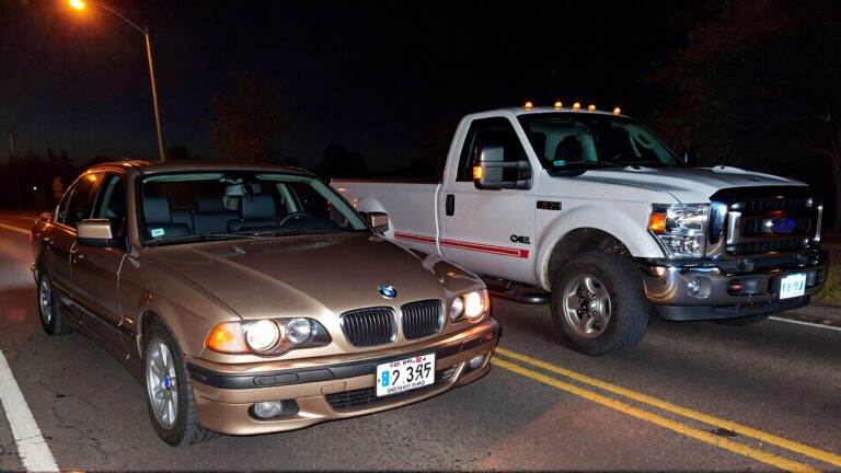 Juris Digital un sed&aacute;n BMW m&aacute;s antiguo y una camioneta Ford F250 en la carretera de noche 5b227645 c32f 4df2 9951 8c7e5459ad67