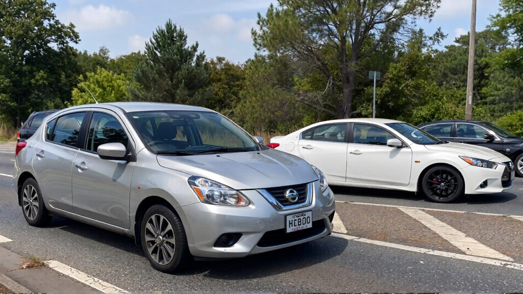 Juris digital a silver Nissan Versa a white sedan a white coupe and a black 24e5596b 87dc 4afd a3ca fdebf8cedf0d 1