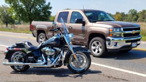 Motorcycle parked beside a pickup truck.