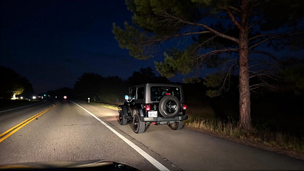 Samantha parian a jeep on the road near a tree in the highway at night cdbca656 f6ef 4a90 b916 45001b729160