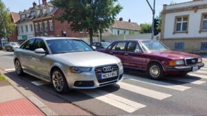 Two cars parked at intersection.