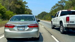 Silver Toyota Camry and white SUV