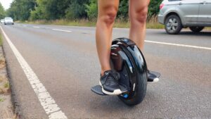 Person riding electric unicycle on road