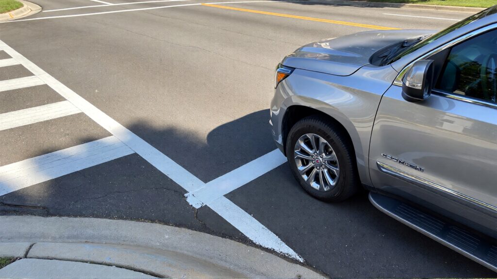 Juris digital a silver GMC SUV on the road near a pedestrian lane 3bf521ea 3664 470e 9bf6 b2ea1a946708