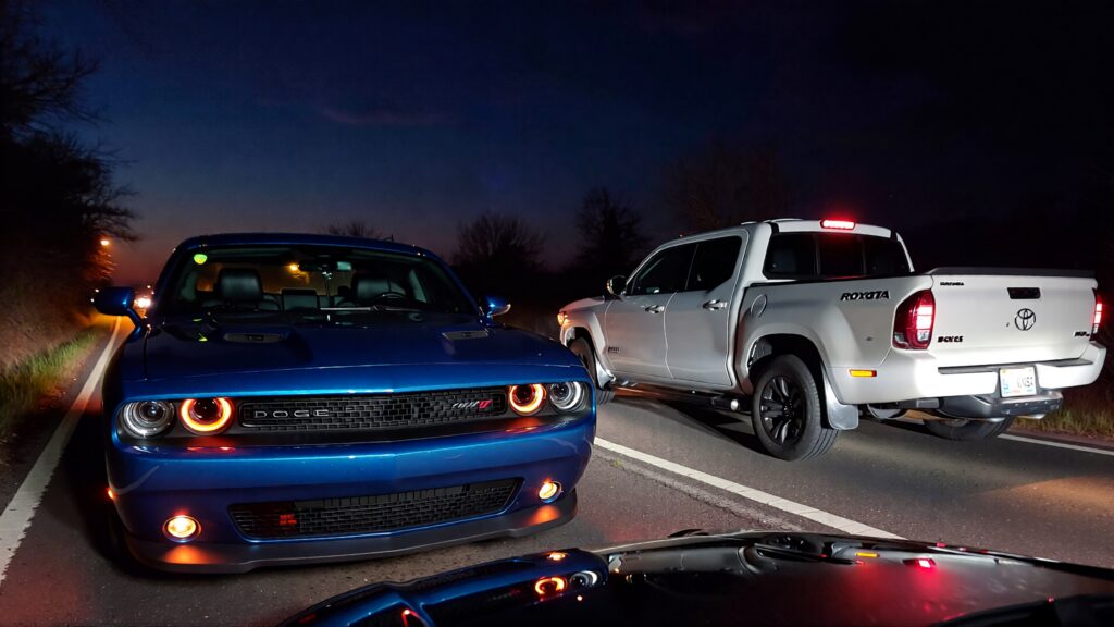 Samantha parian a Dodge Challenger and a Toyota Tacoma on the road at night c4610c6f 6439 43e1 aea4 a36288745343
