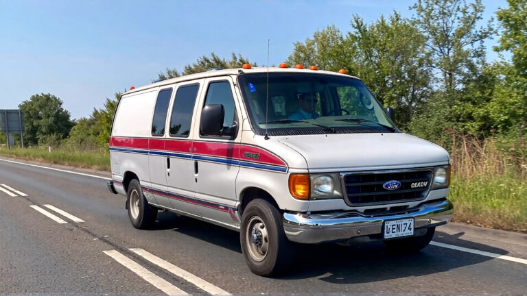 White Ford Econoline van driving