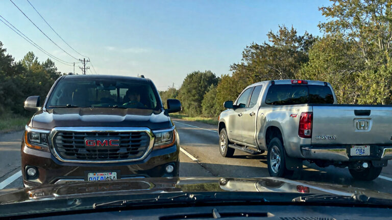 Two trucks parked on the road.