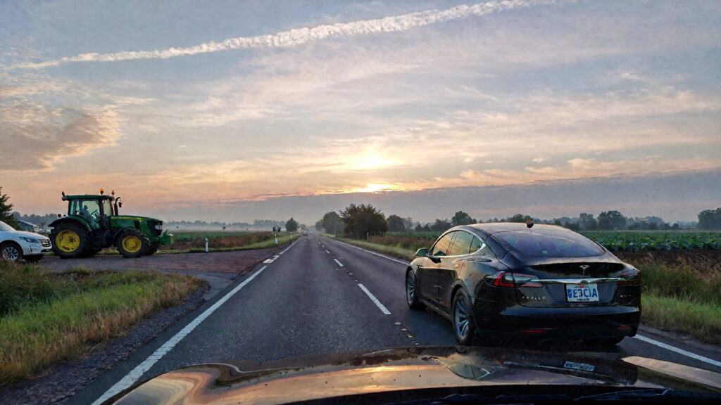 Samantha parian a Tesla and a farm tractor on the road at dawn 34ae29e1 d0fc 4bdc beab 3d723b7c0694