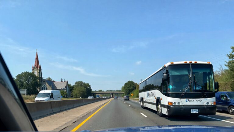 Bus and van on highway, church nearby