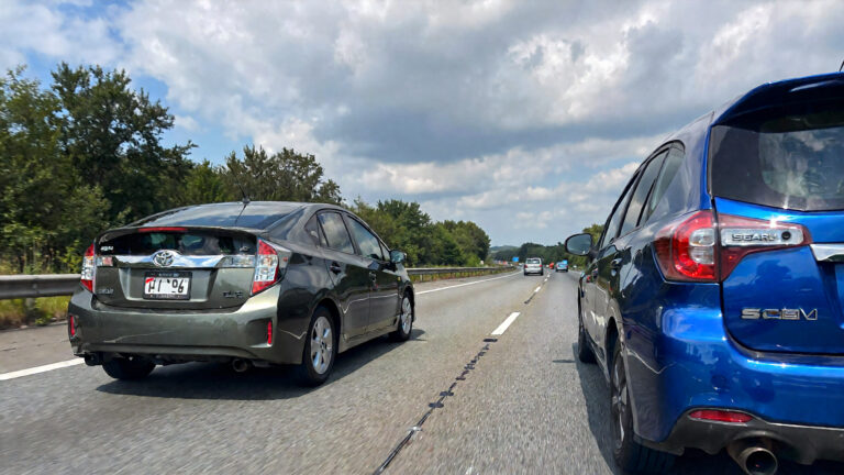 Two cars on a highway.