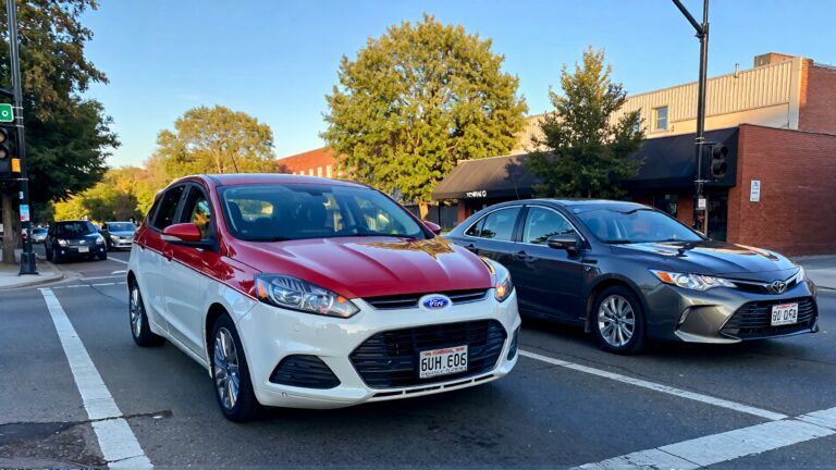 Two cars at a street intersection