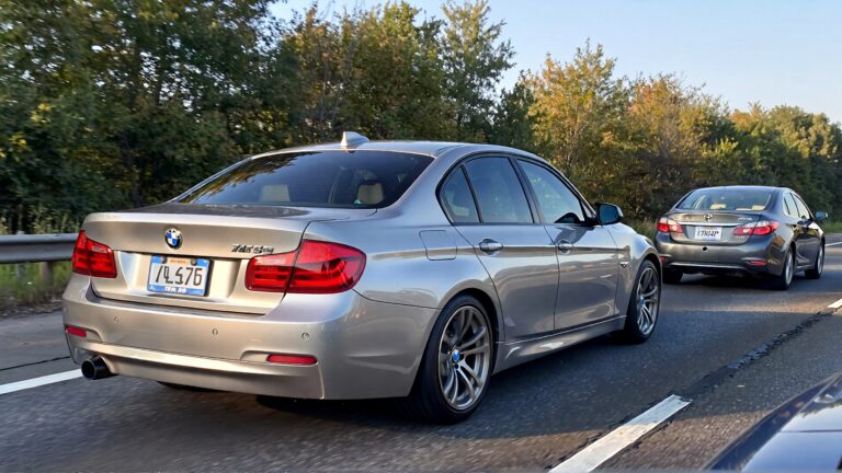 Silver BMW and Toyota on highway