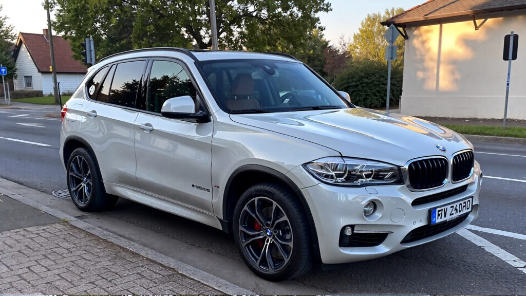 Samantha parian a white BMW SUV on the street in the morning fb9ce667 57b6 4b35 af08 4da565f526e1