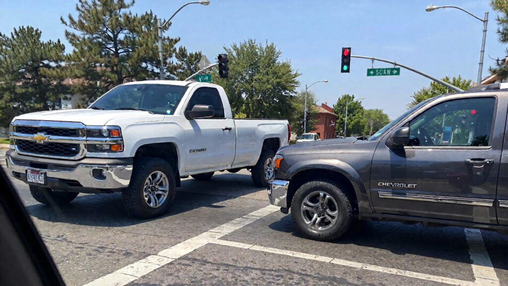 Samantha parian A white pickup truck and a gray Chevrolet Blazer on the street in a6323b54 b08c 4ba7 867a 44375750d0e5