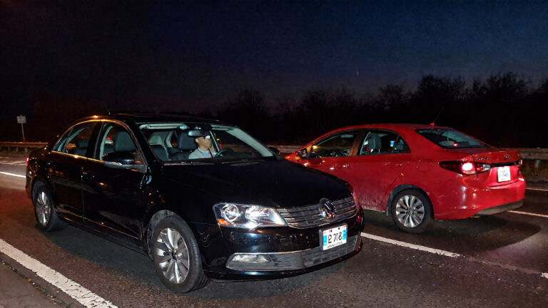 Two cars parked on the road.