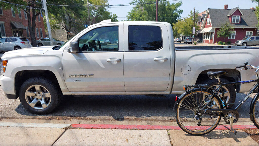 Samantha parian a white 2017 Chevrolet Silverado and a bicycle on the street 3dbd46f3 b2c9 4088 99cc 56e9b1457fd0