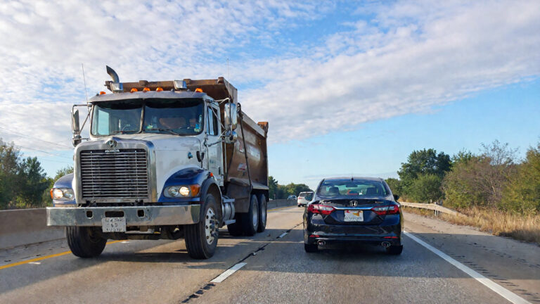 Dump truck and sedan on highway